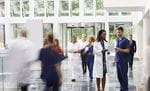 doctors reviewing document in hospital lobby (image)