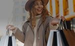 Woman holding shopping bags in retail setting (image)
