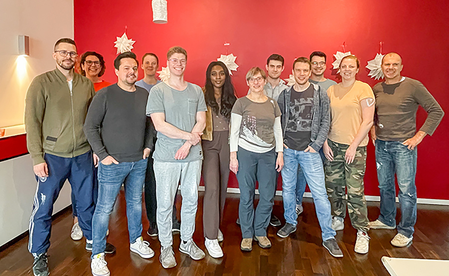 Group of people in front of red wall