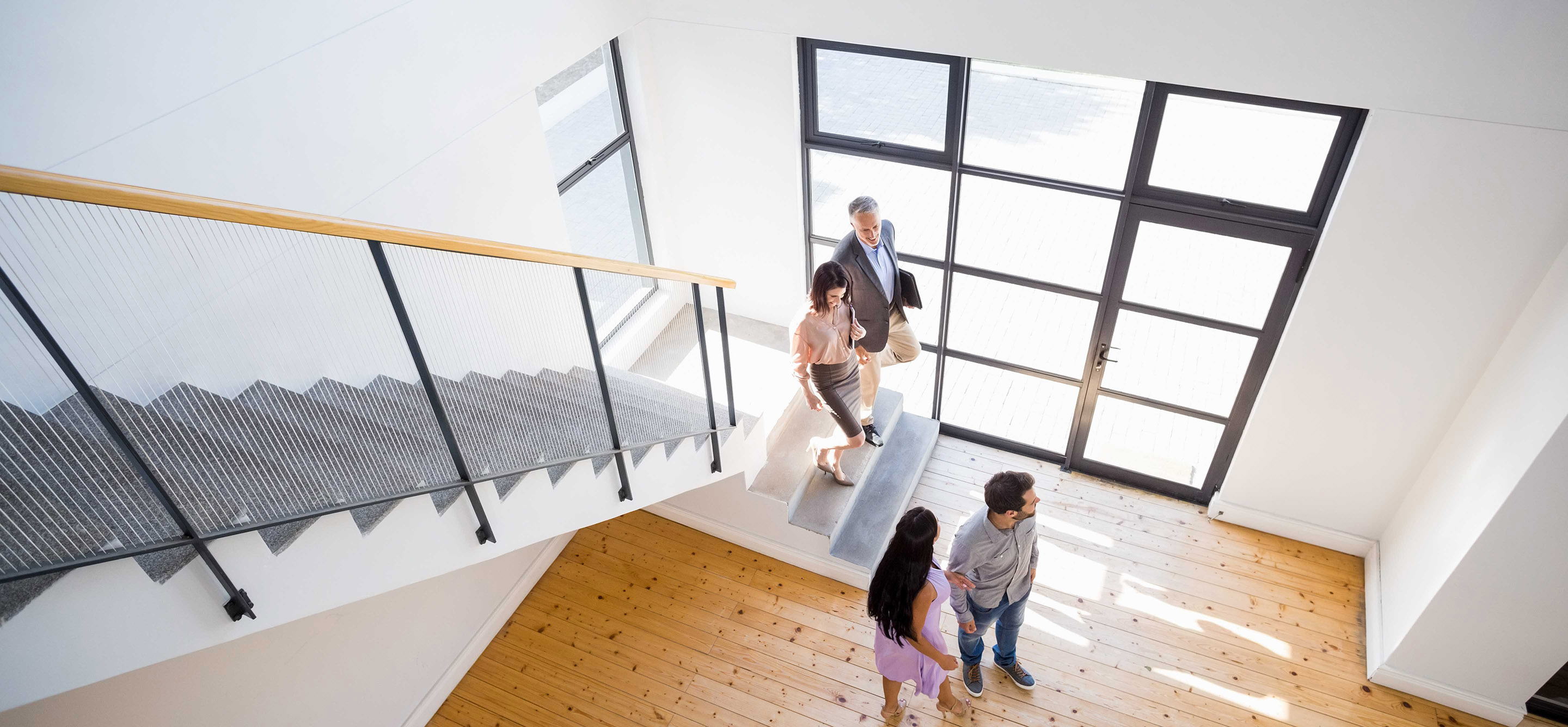 Four people in a modern house, viewed from above