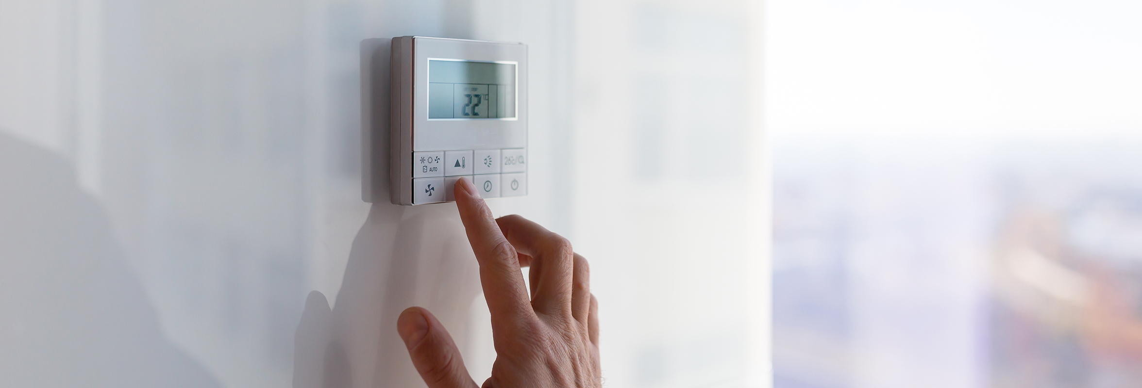 The air conditioning and heating control panel for the office on a white wall