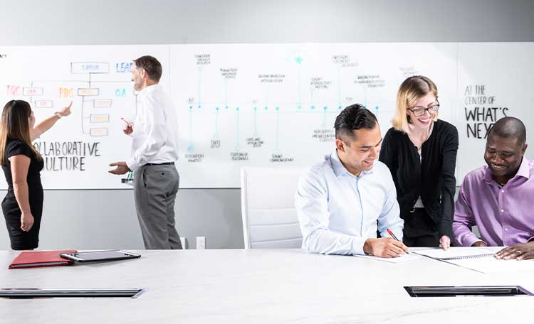 A group of diverse colleagues working together in the conference room