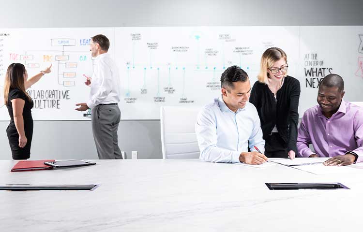 A group of diverse colleagues working together in the conference room