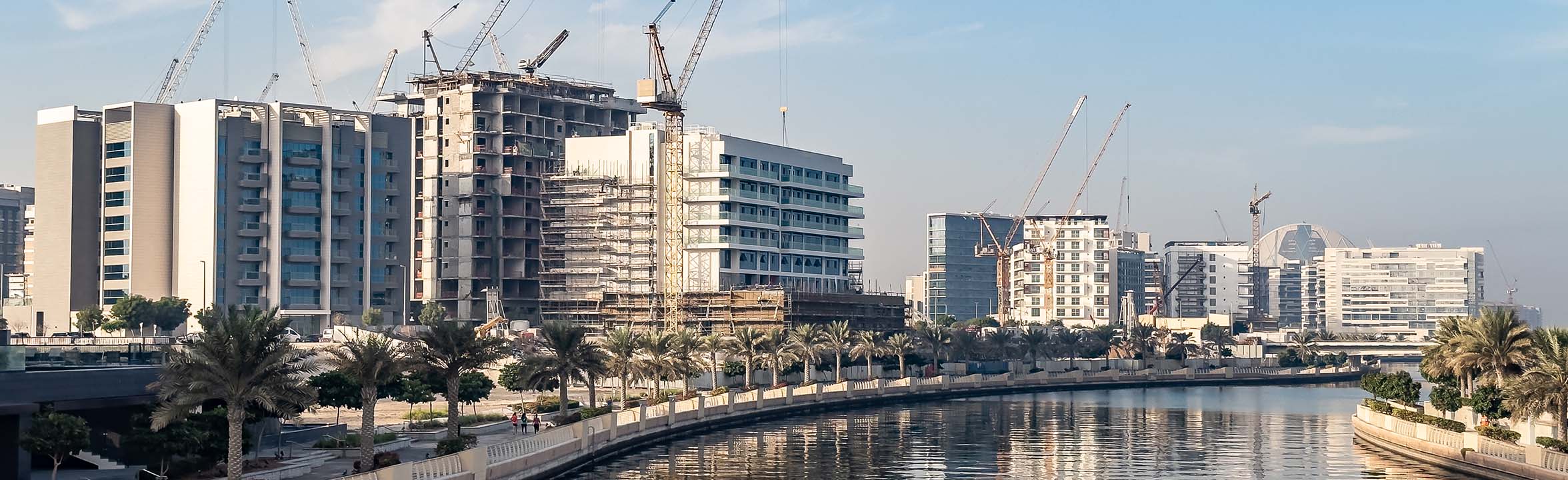 Residential apartment buildings under construction along the waterfront promenade