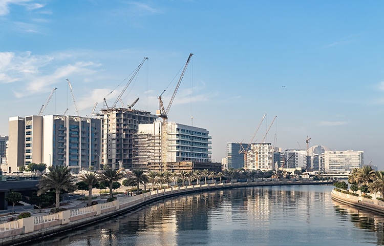 Residential apartment buildings under construction along the waterfront promenade