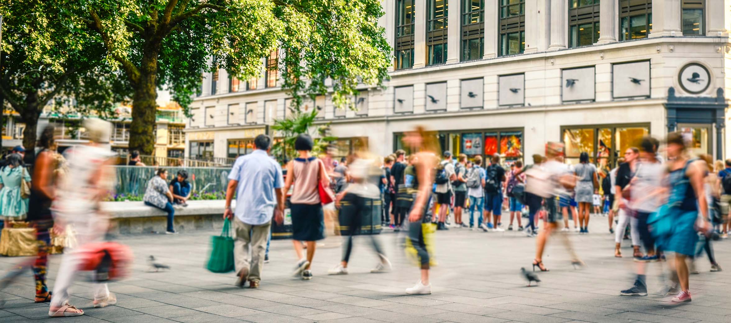Busy motion blurred shopping street scene