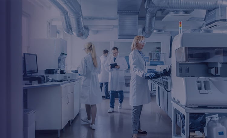 Team of research scientists working on computers in a modern laboratory