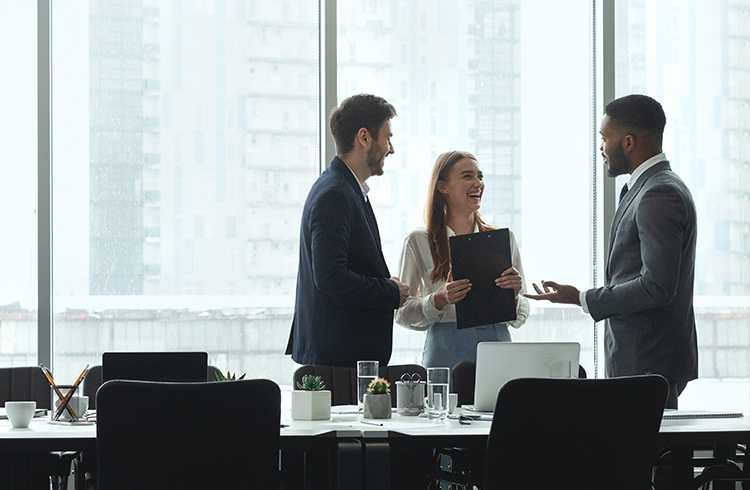 Group of diverse business people talking in office with big windows