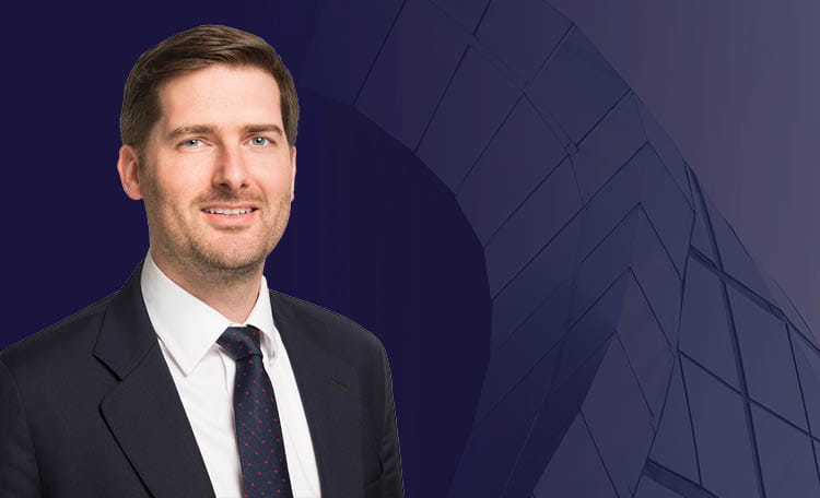 Daniel Turner portrait man in suit on navy blue background