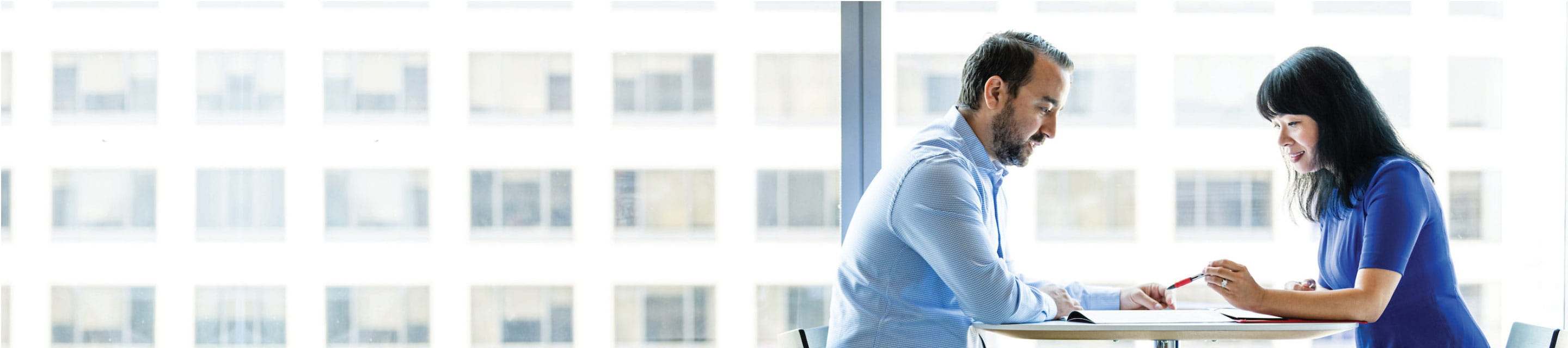 man and woman sitting at desk