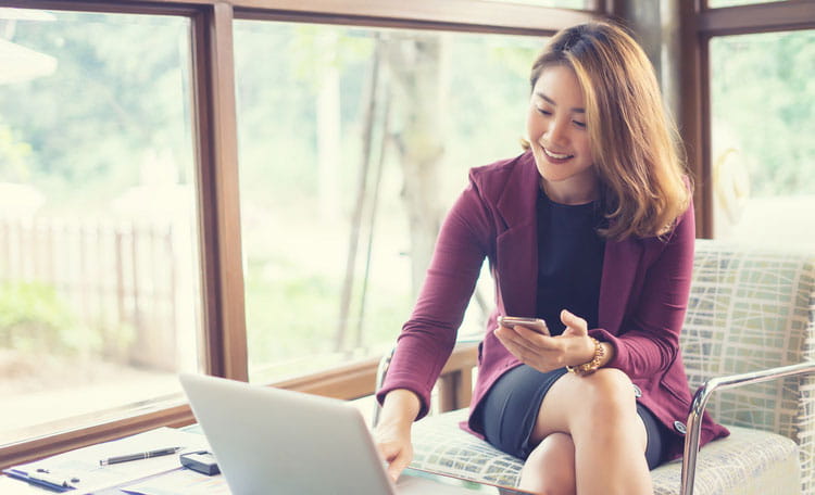 Woman on laptop and cellphone